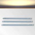 Three LED kitchen cabinet warm white strip lights on a white background