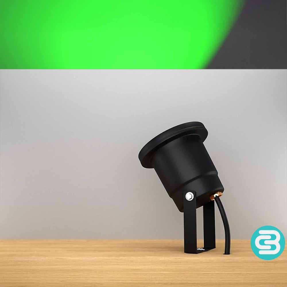 Black outdoor light fixture on a wooden surface with a green LED light on a gray background.