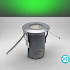 Green LED deck light fixture on a gray background