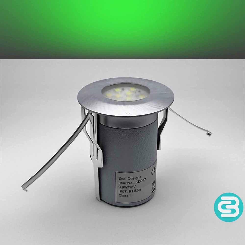 Green LED deck light fixture on a gray background