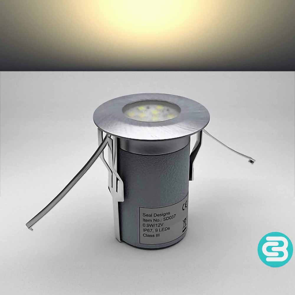 Warm white LED deck light fixture on a gray background