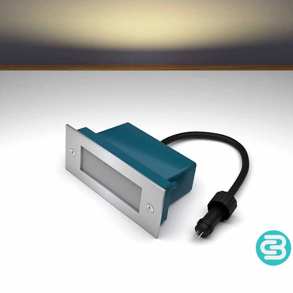 Warm white LED wall light with a black cable on a gray background