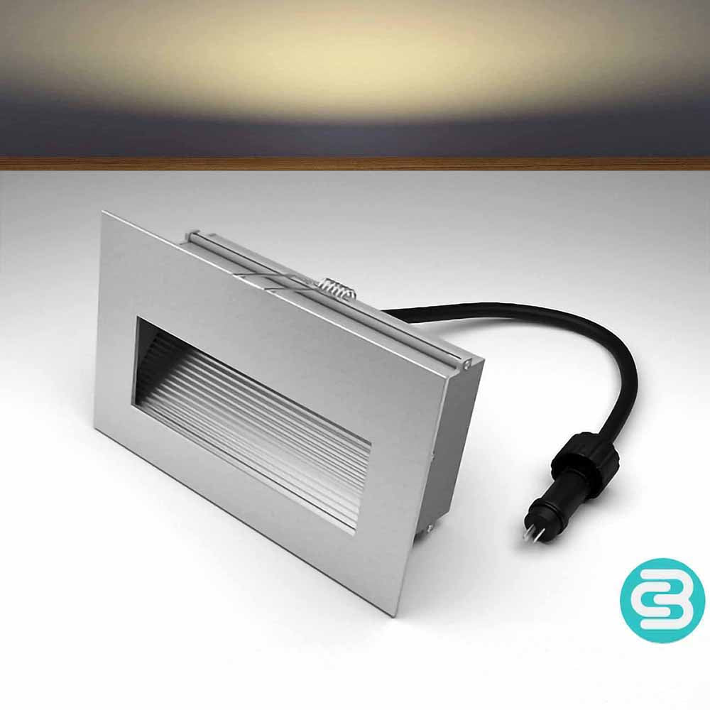 Warm white LED wall downlight with a black cable on a gray background