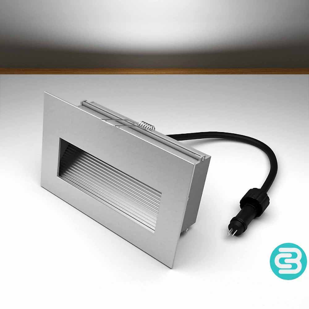 White LED wall downlight with a black cable on a gray background