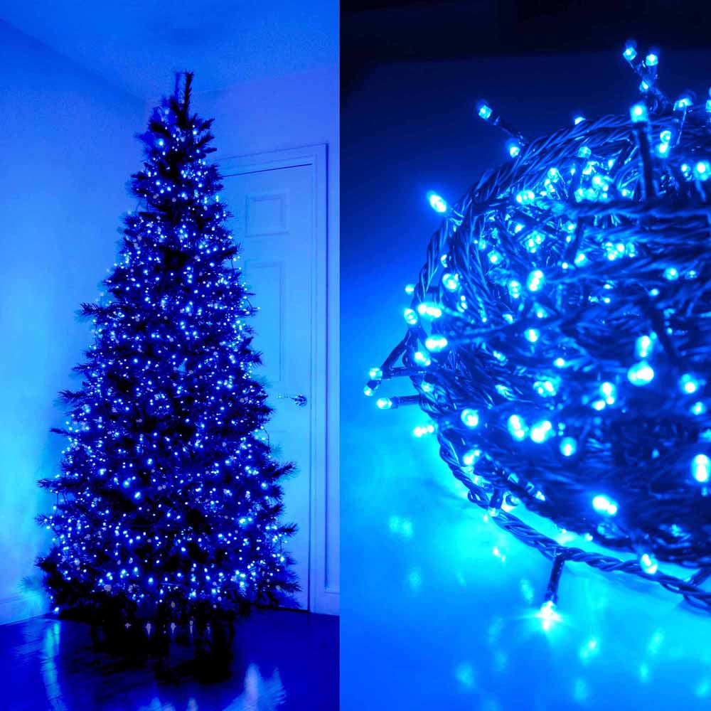 Blue LED string lights on a Christmas tree and coiled on a surface.