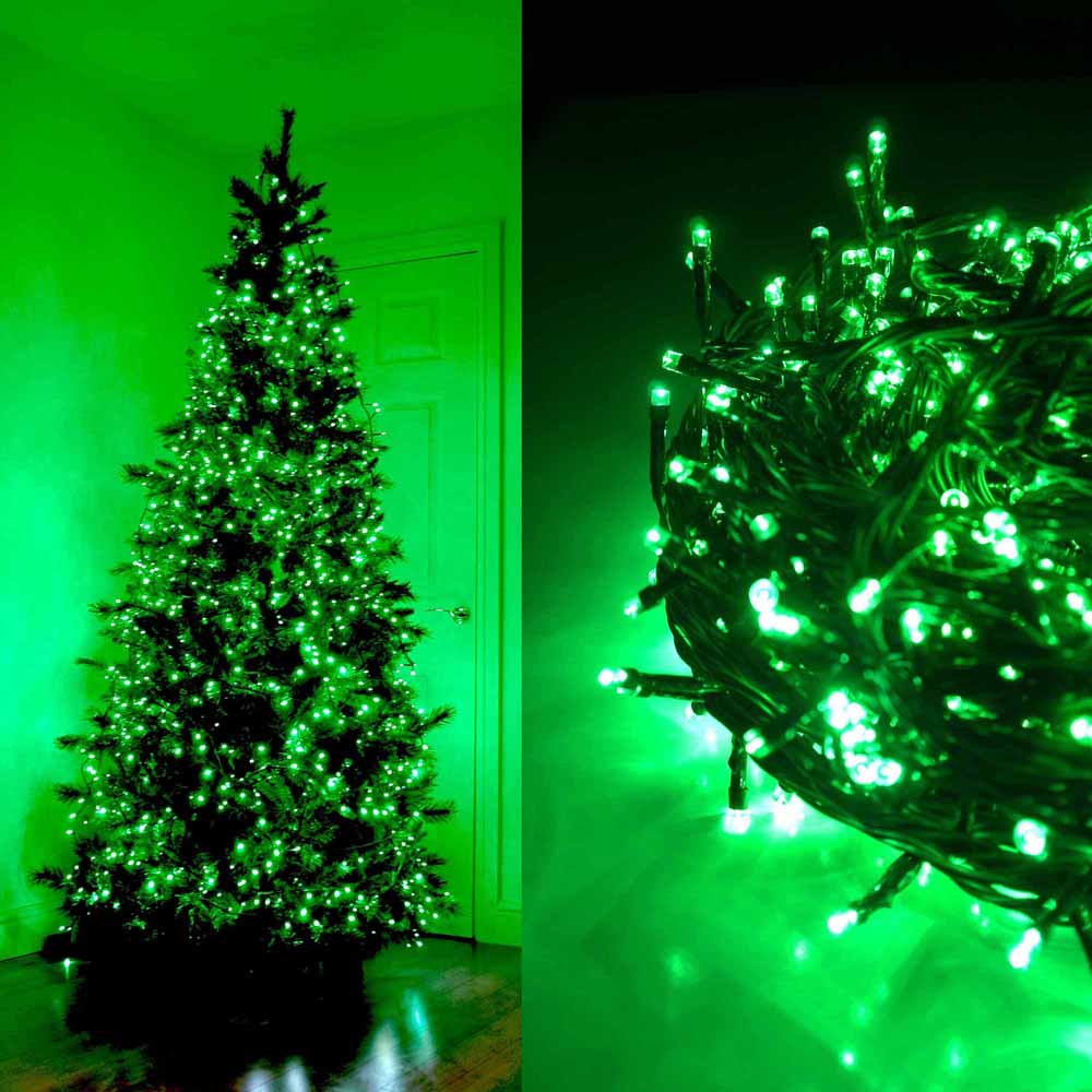 Green LED string lights on a Christmas tree and coiled on a surface.