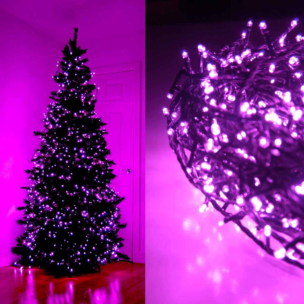 Pink LED string lights on a Christmas tree and coiled on a surface.