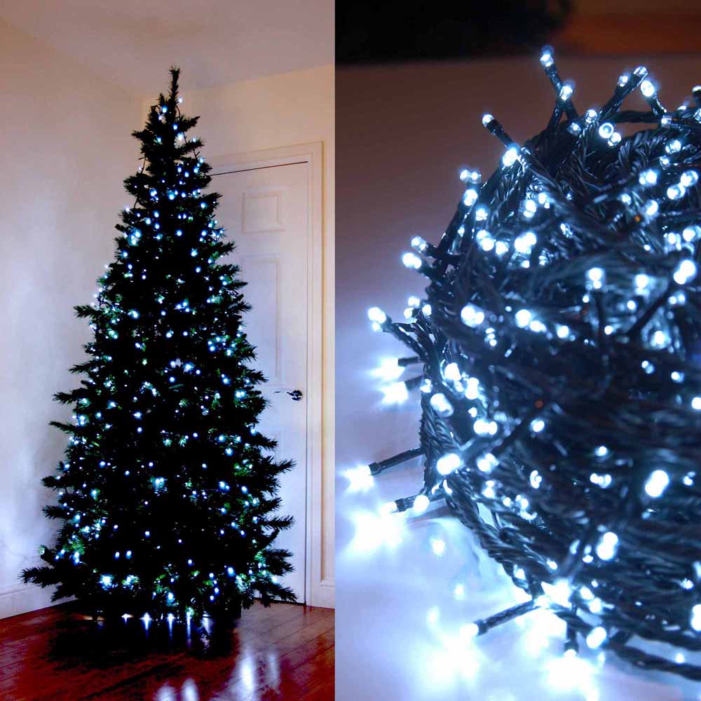 White LED string lights on a Christmas tree and coiled on a surface.